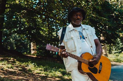 guitar man standing and playing guitar during daytime leisure activities